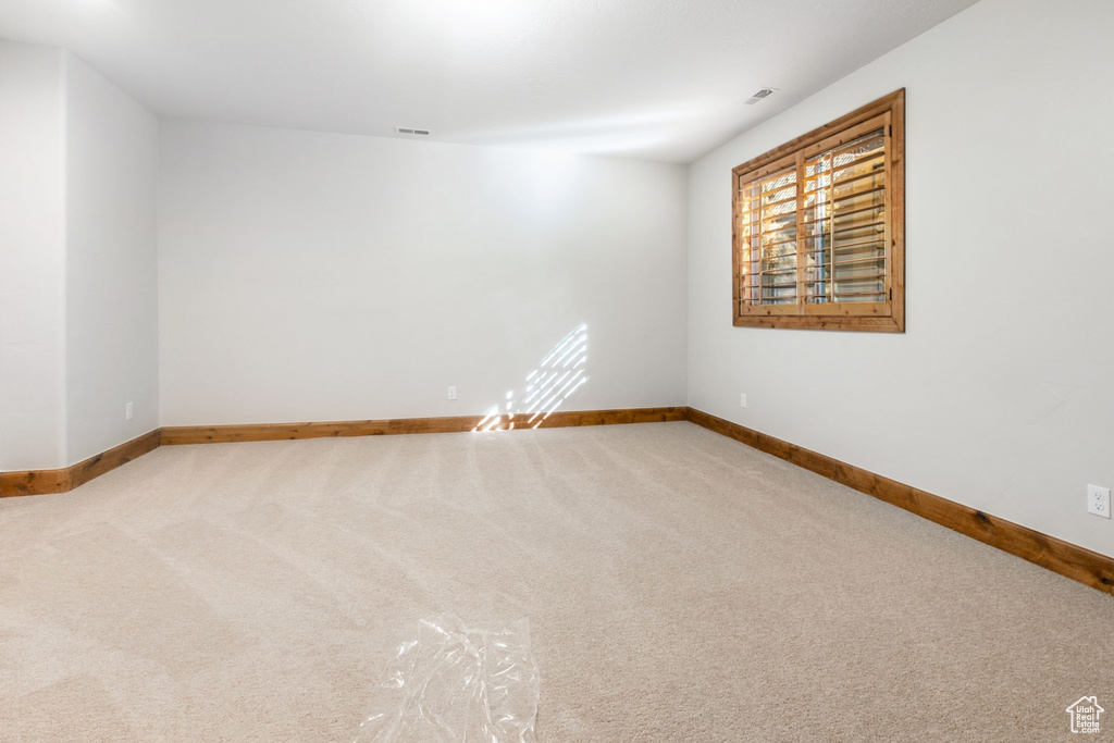 Unfurnished room featuring light colored carpet