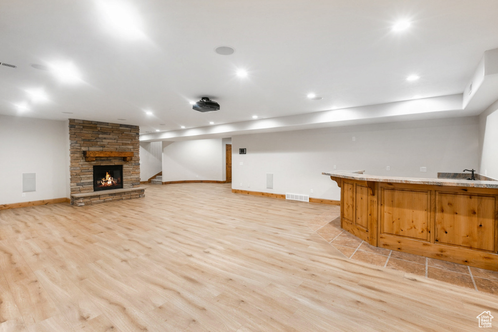 Unfurnished living room with a fireplace and light wood-type flooring