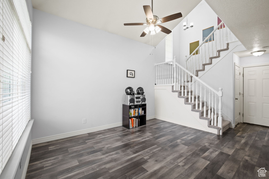 Entryway featuring dark hardwood / wood-style flooring, ceiling fan, and a towering ceiling