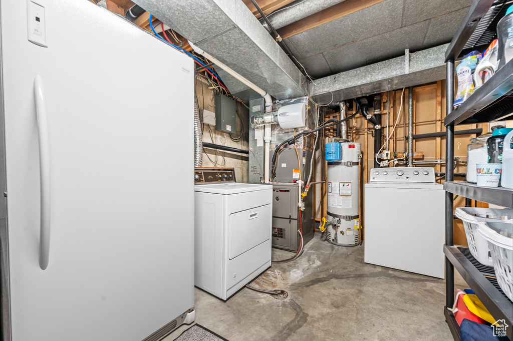 Basement featuring water heater and washing machine and dryer