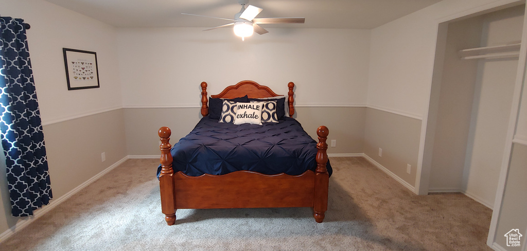 Bedroom featuring ceiling fan and carpet
