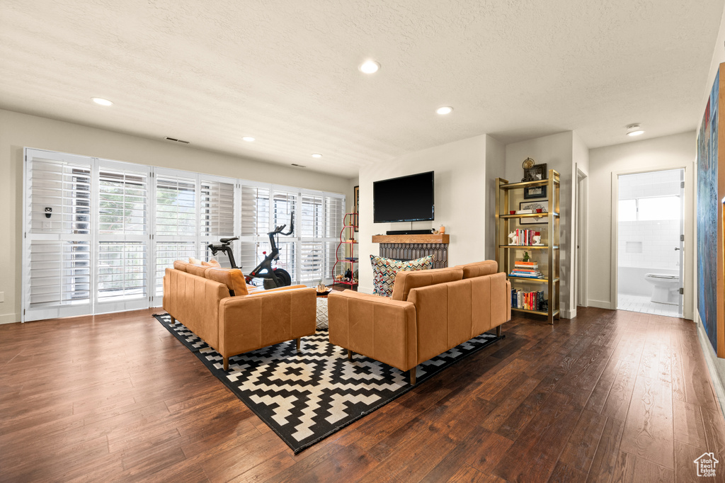 Living room with dark wood-type flooring