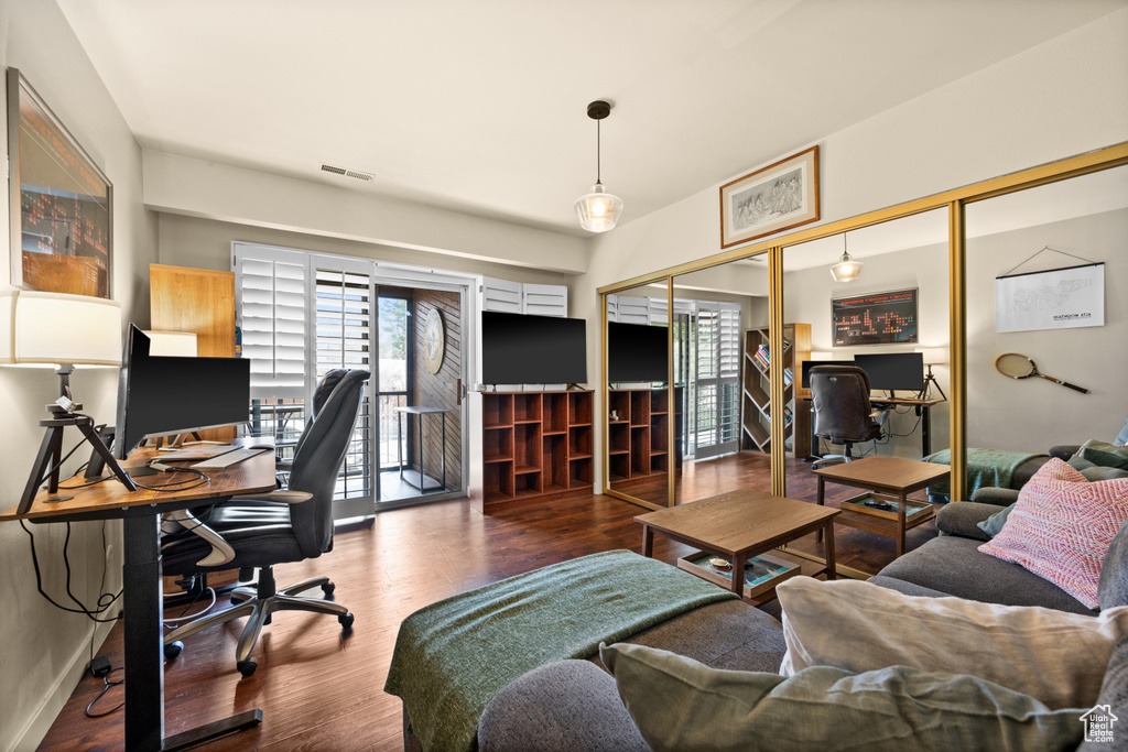 Home office featuring hardwood / wood-style flooring and a healthy amount of sunlight