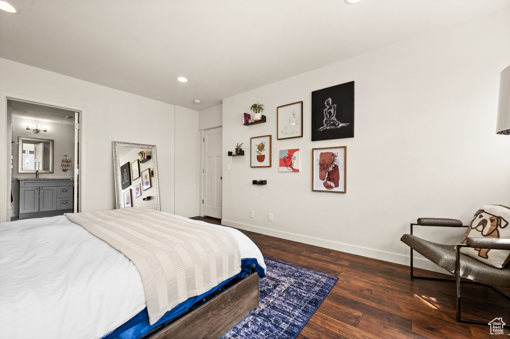 Bedroom featuring ensuite bath and dark hardwood / wood-style flooring