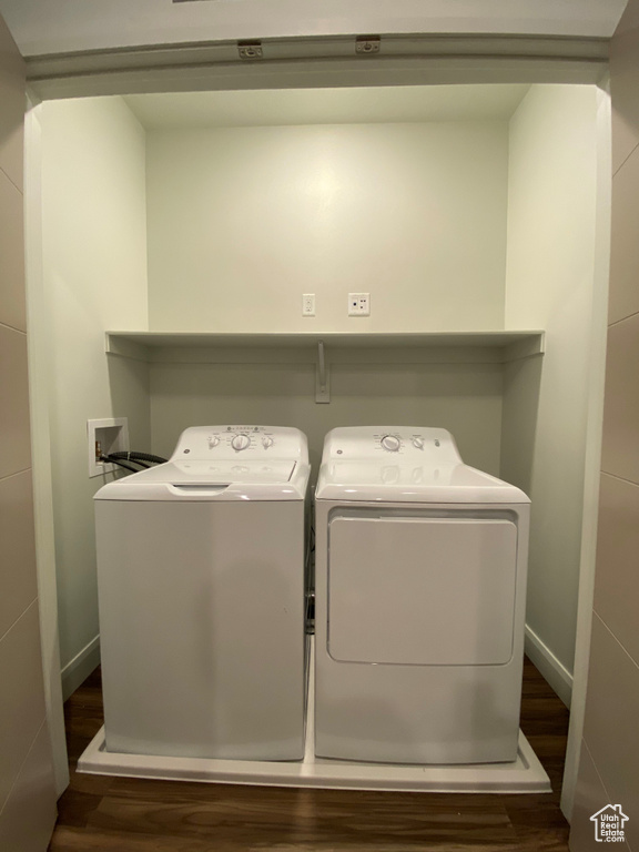 Laundry room featuring wood-type flooring, separate washer and dryer, and washer hookup