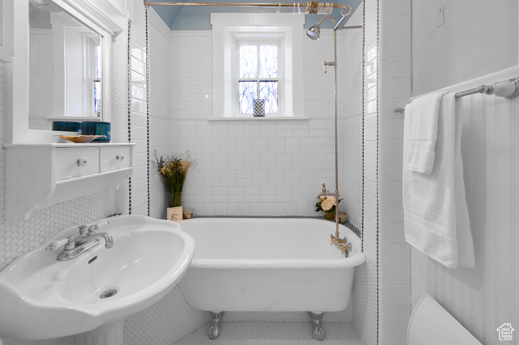 Bathroom featuring tile walls and sink