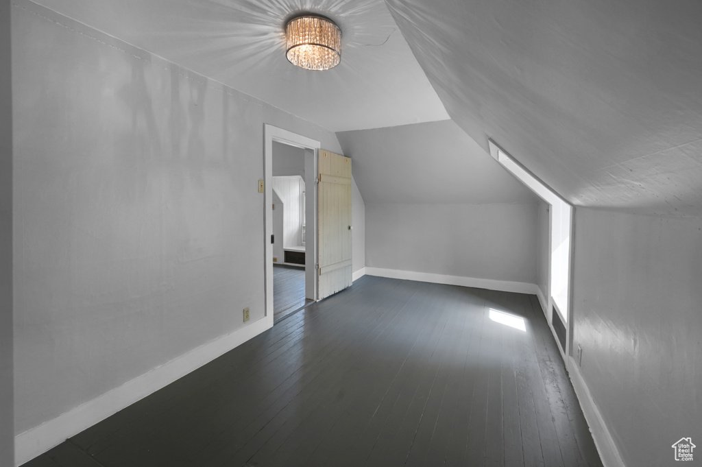 Bonus room featuring lofted ceiling and dark wood-type flooring