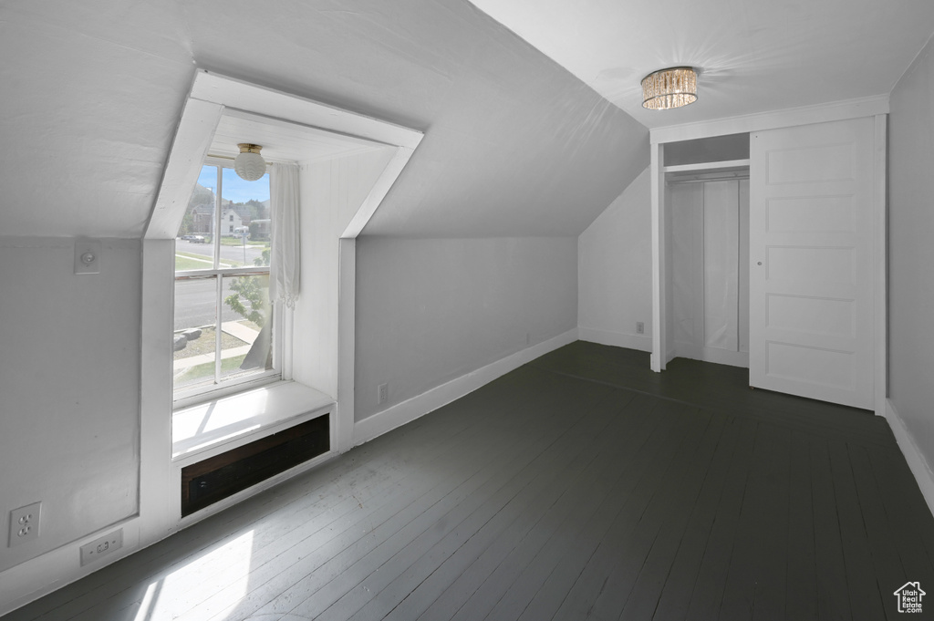 Bonus room featuring vaulted ceiling and dark hardwood / wood-style floors