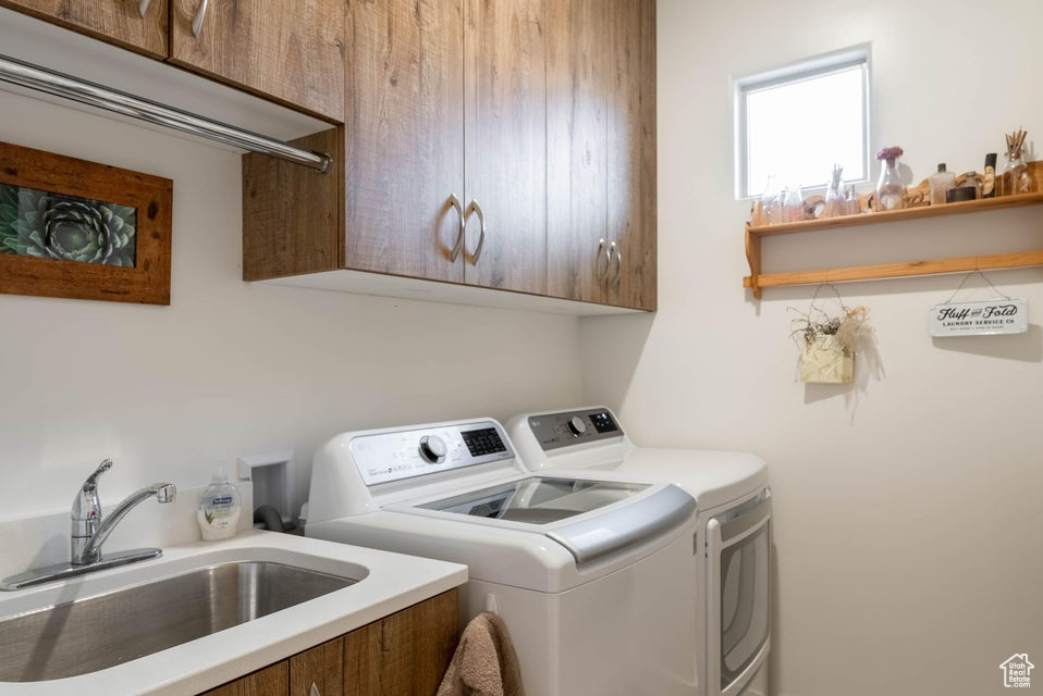 Clothes washing area with sink, washing machine and dryer, and cabinets