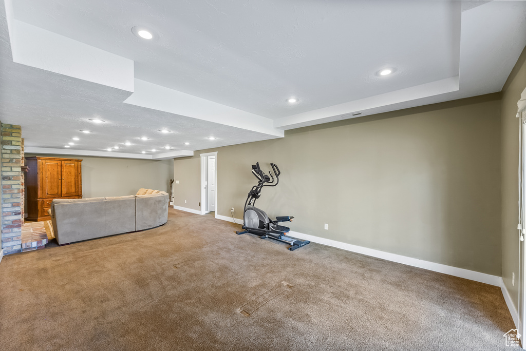 Workout room featuring brick wall and carpet flooring