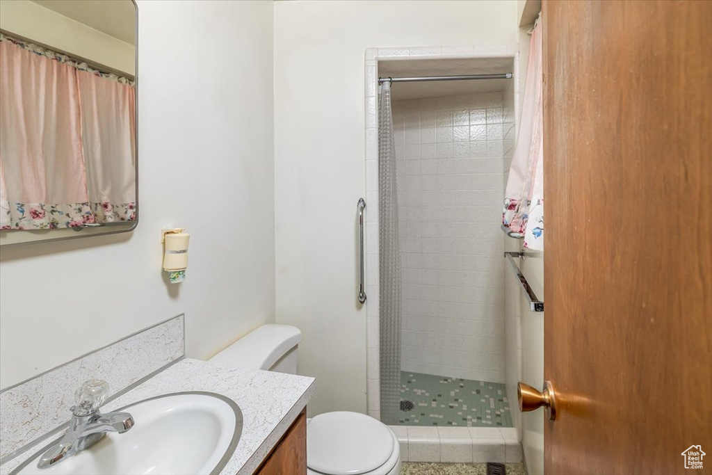 Bathroom with a shower with shower curtain, toilet, and oversized vanity