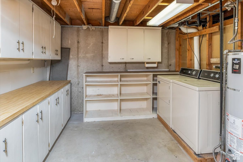 Basement with water heater and separate washer and dryer
