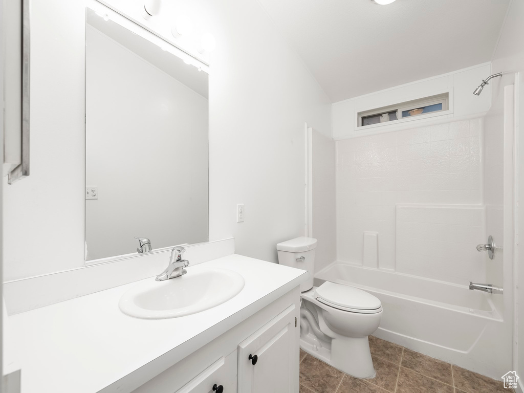 Full bathroom featuring bathtub / shower combination, oversized vanity, tile floors, and toilet