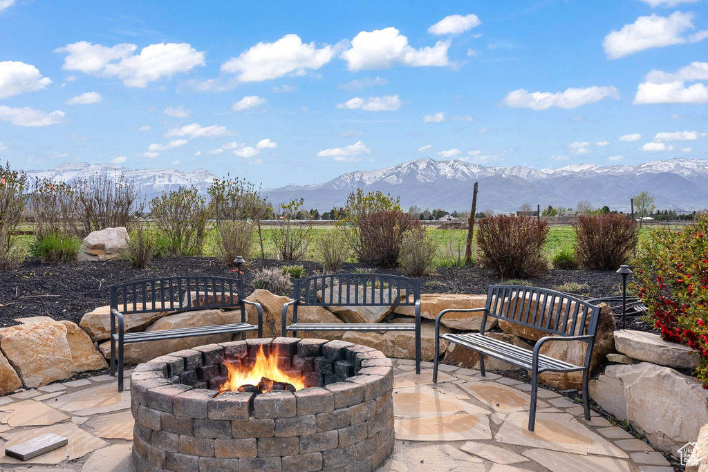 View of terrace featuring a mountain view and an outdoor fire pit