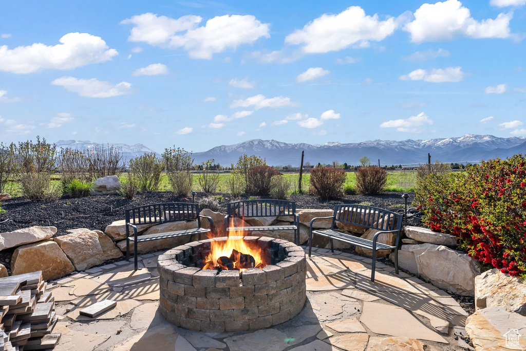 View of patio / terrace with a mountain view and an outdoor fire pit