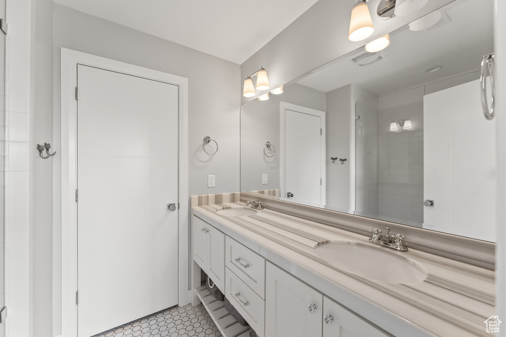 Bathroom with tile flooring, oversized vanity, and double sink