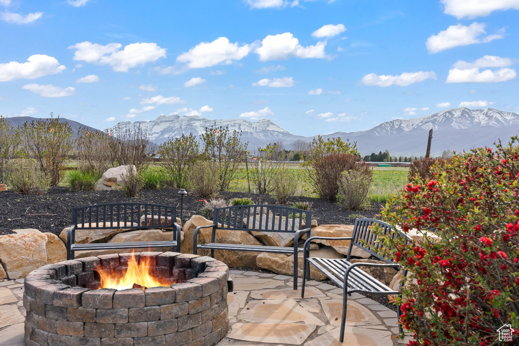 View of terrace with a mountain view and an outdoor fire pit