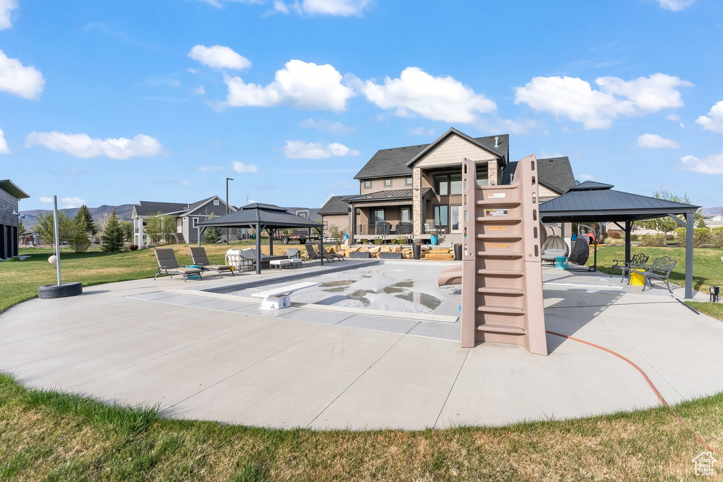 View of property\\\\\\\'s community with a yard and a gazebo