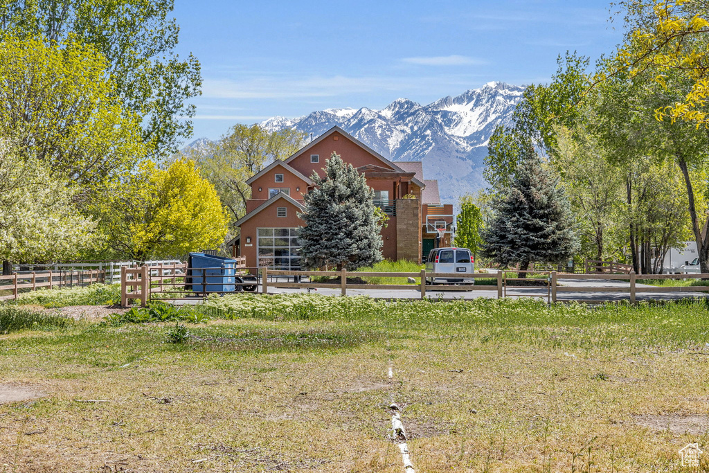 View of front of property with a mountain view and a rural view
