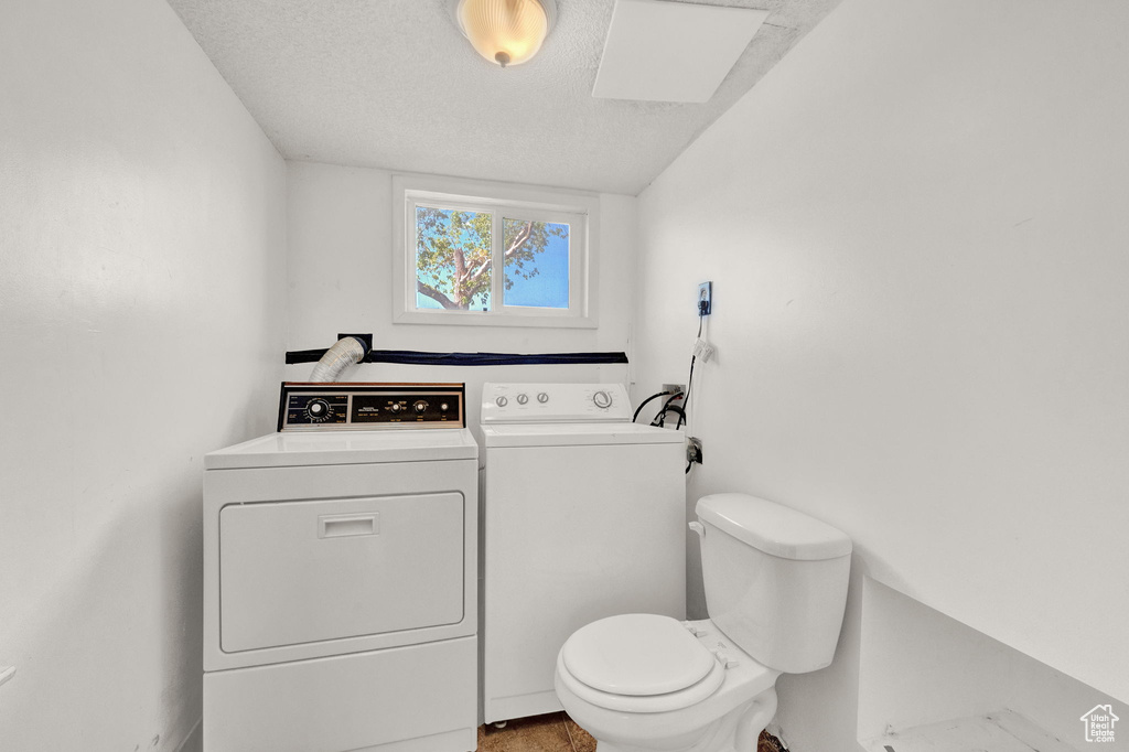 Laundry area with a textured ceiling and washer and dryer