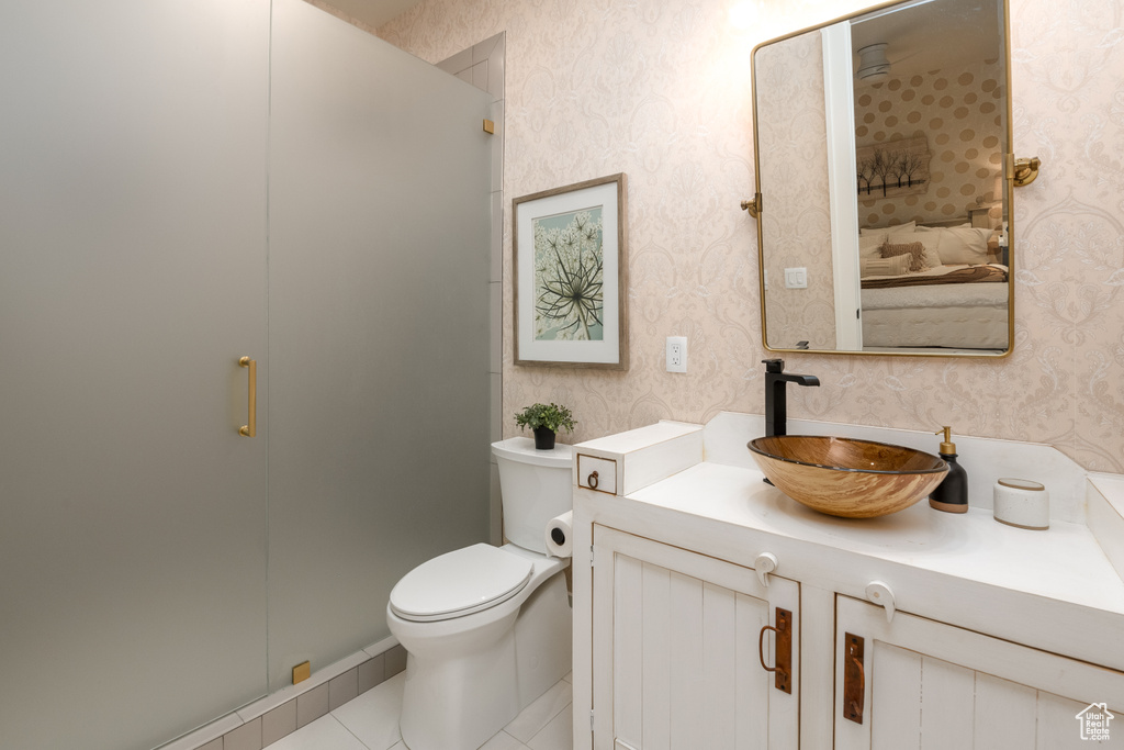 Bathroom with walk in shower, vanity, toilet, and tile flooring