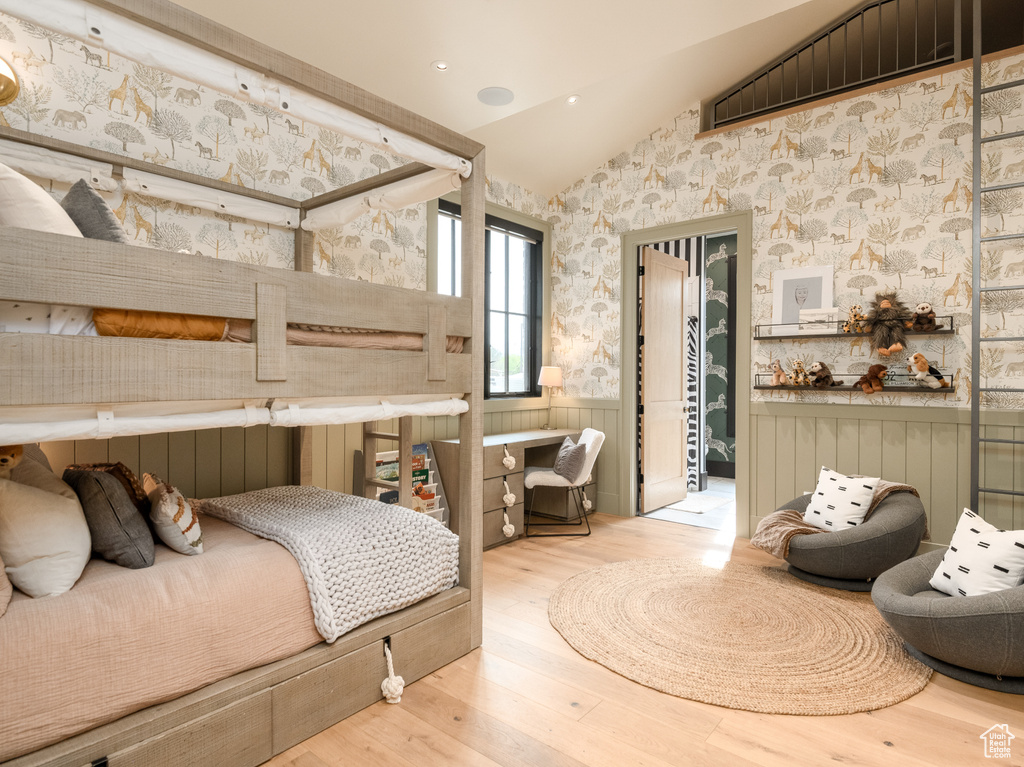 Bedroom with light hardwood / wood-style flooring and vaulted ceiling