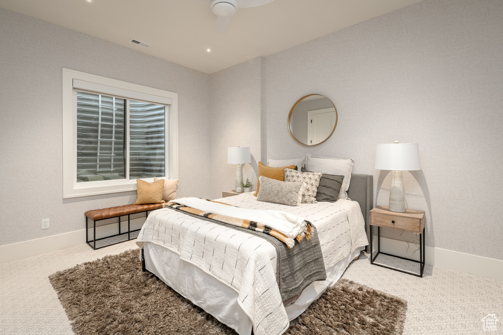 Carpeted bedroom with ceiling fan