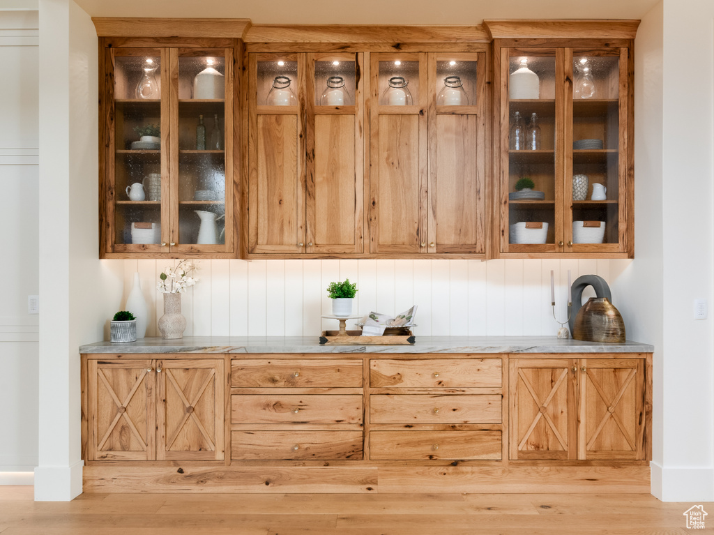 Bar with light hardwood / wood-style floors