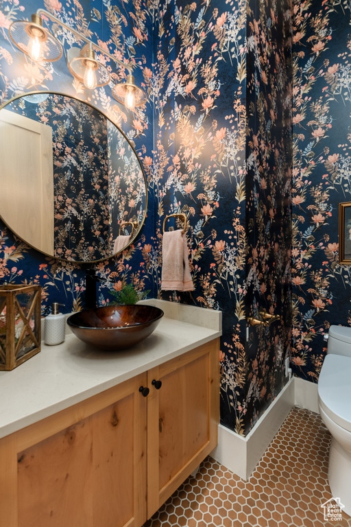 Bathroom with tile flooring, vanity, and toilet