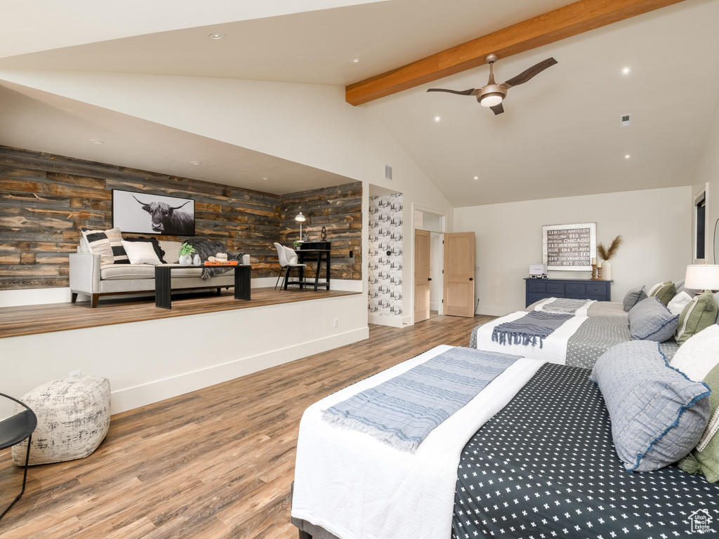 Bedroom featuring hardwood / wood-style floors, ceiling fan, high vaulted ceiling, and beam ceiling