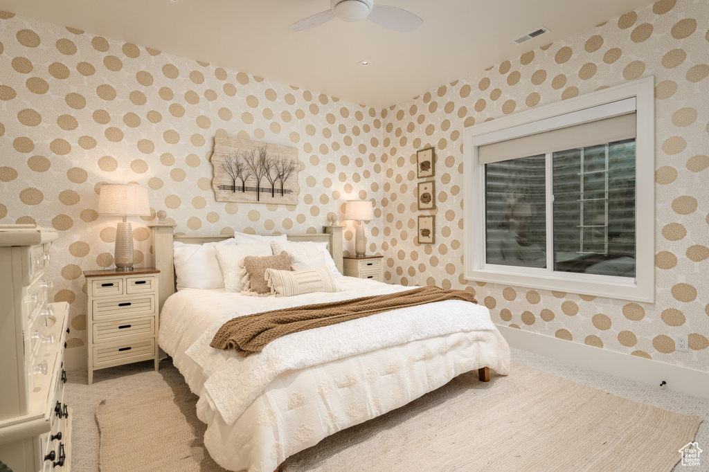 Bedroom featuring light colored carpet and ceiling fan