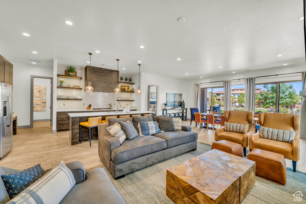 Living room with sink and light wood-type flooring