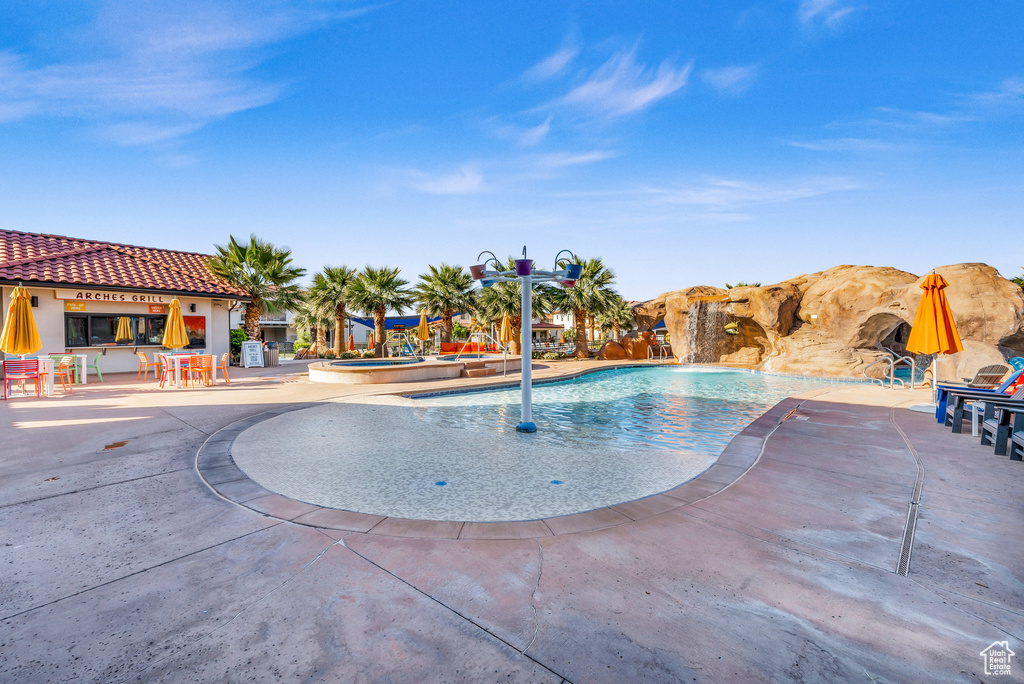 View of swimming pool with a patio area and pool water feature