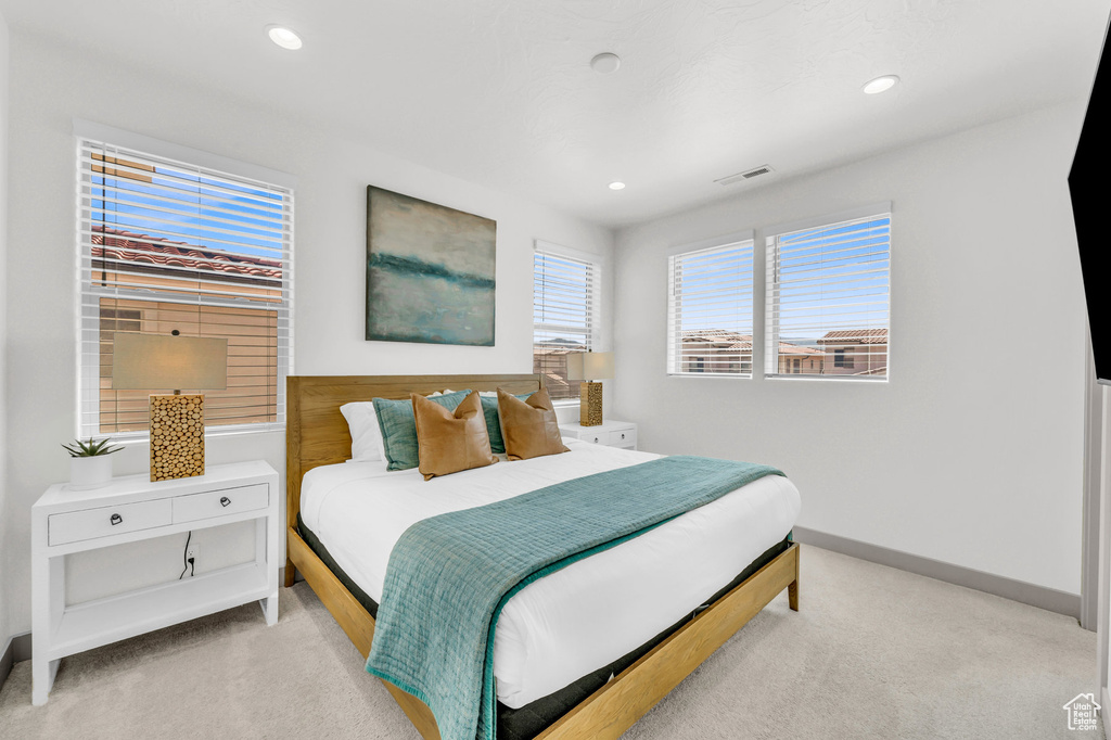 Bedroom with light colored carpet