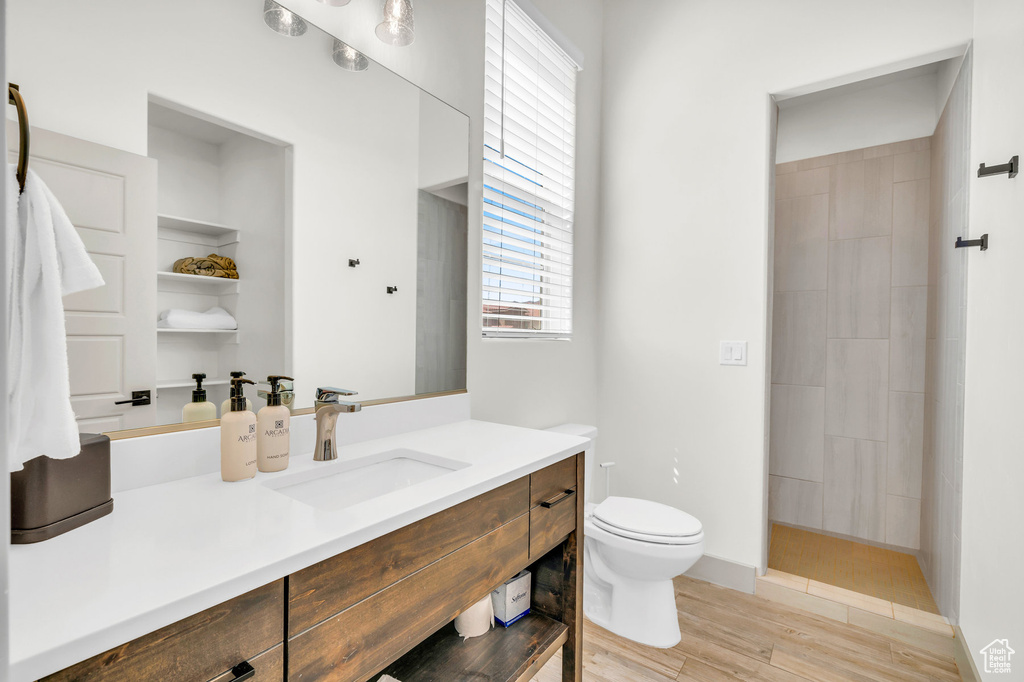 Bathroom featuring hardwood / wood-style floors, vanity, and toilet