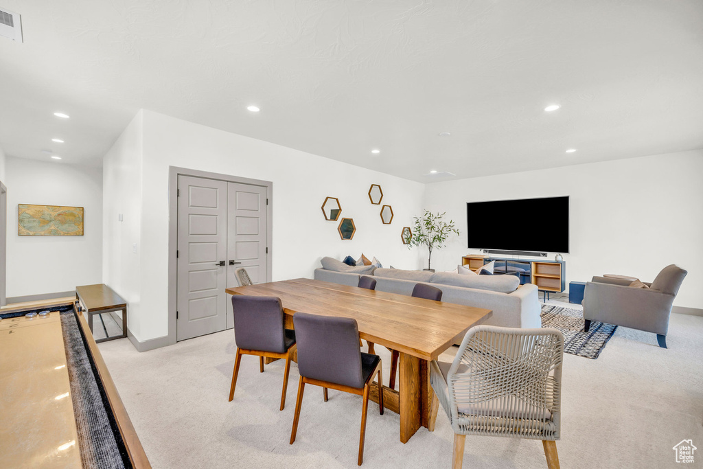 Dining space featuring light carpet