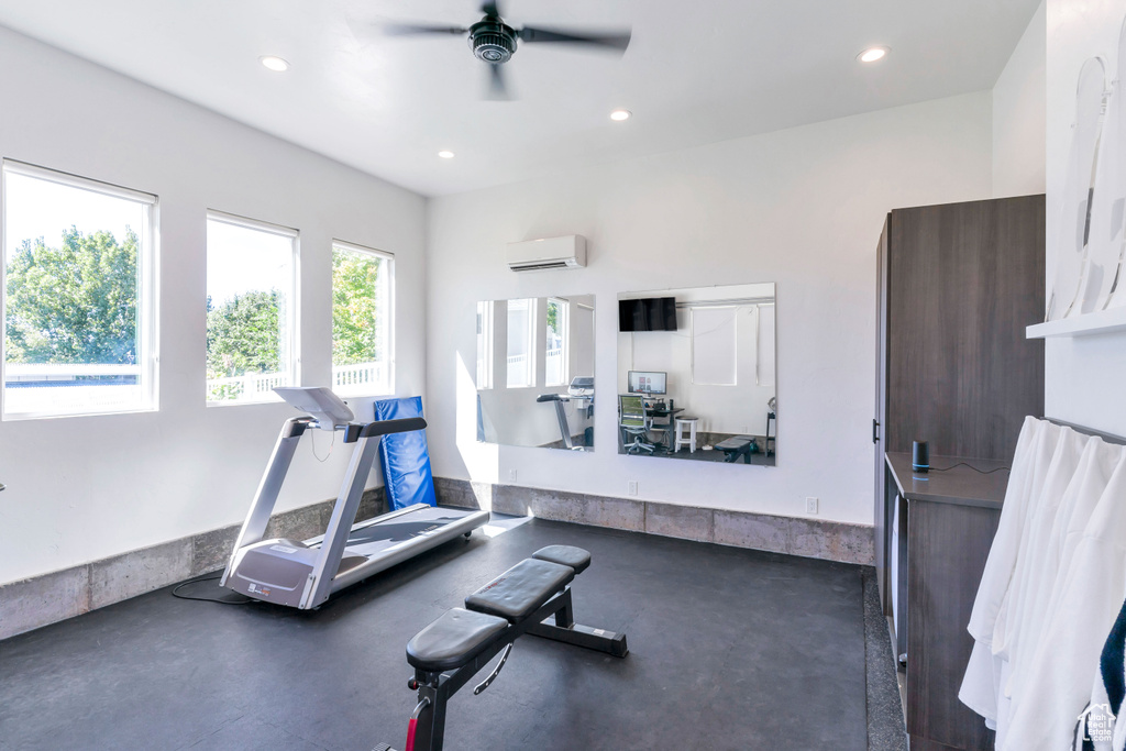 Exercise area with ceiling fan and an AC wall unit