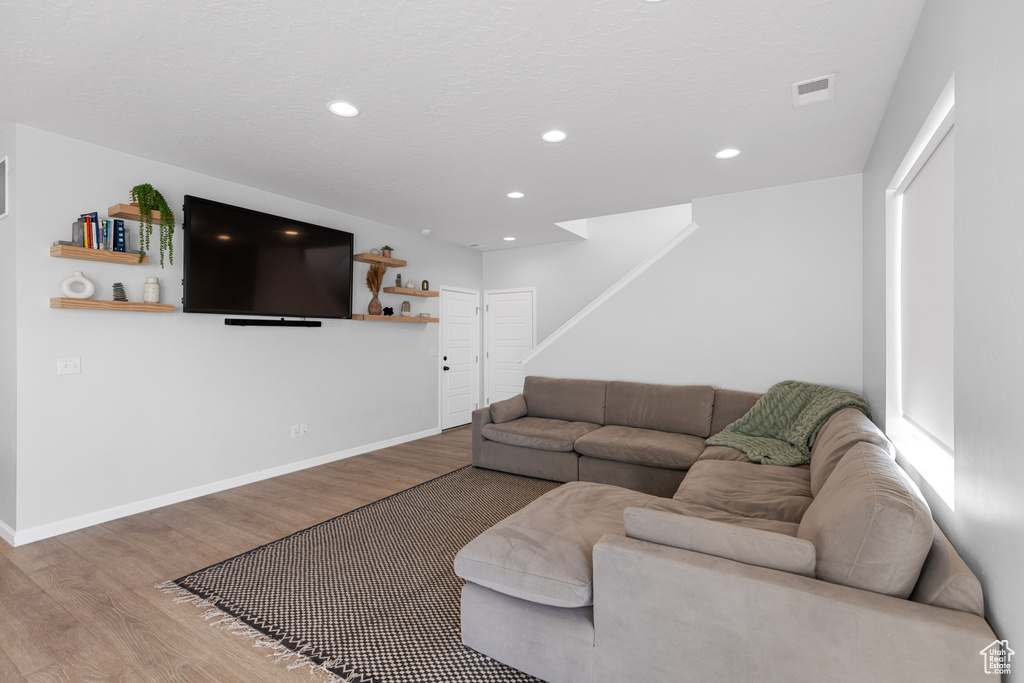 Living room with hardwood / wood-style flooring
