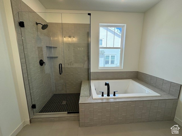 Bathroom featuring independent shower and bath and tile floors
