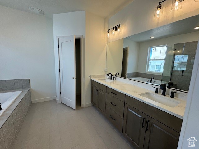 Bathroom with shower with separate bathtub, tile floors, and dual bowl vanity