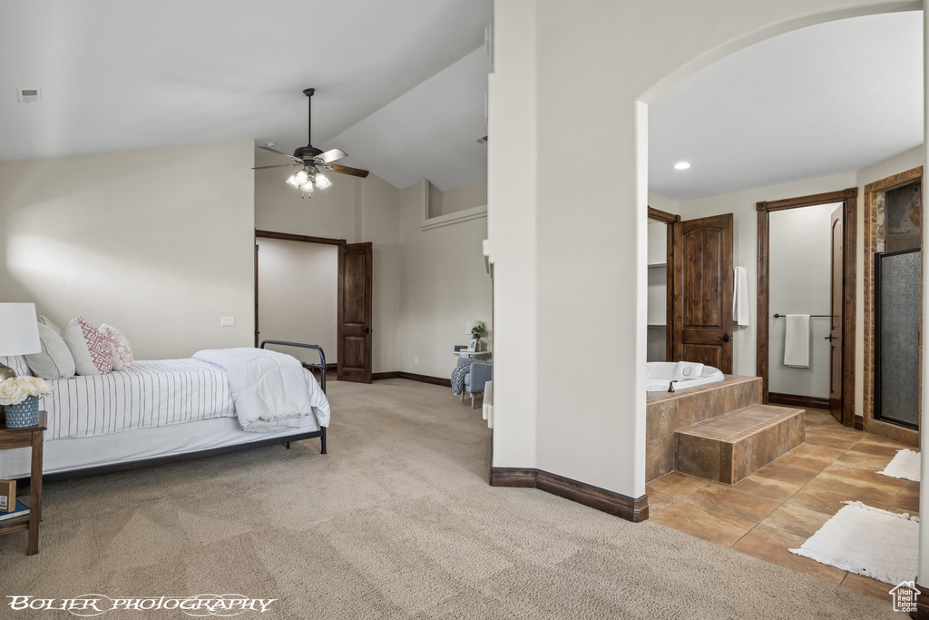 Bedroom featuring carpet, high vaulted ceiling, ceiling fan, and ensuite bathroom
