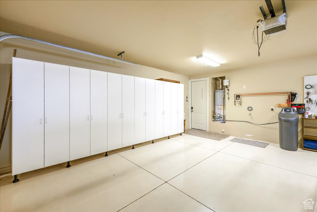Garage with a garage door opener and gas water heater