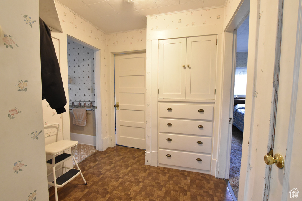 Unfurnished bedroom with dark parquet floors