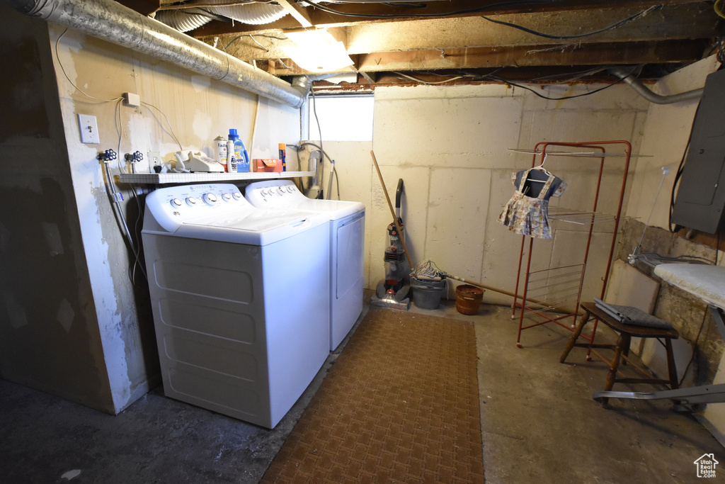Clothes washing area featuring hookup for a washing machine and washing machine and clothes dryer