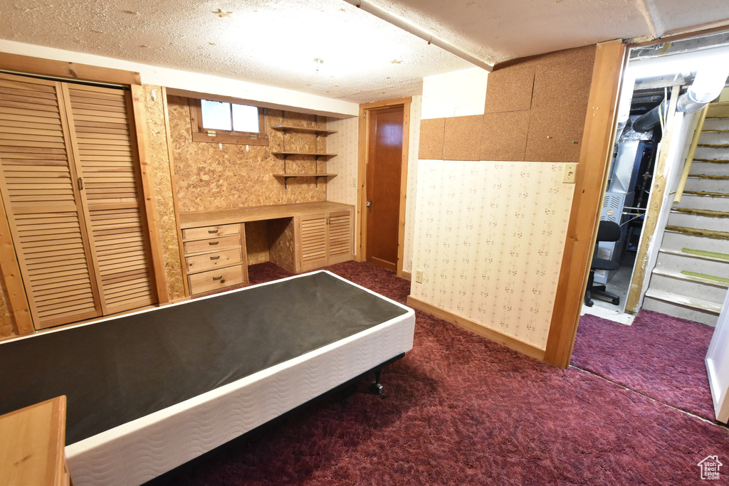 Unfurnished bedroom with carpet floors and a textured ceiling