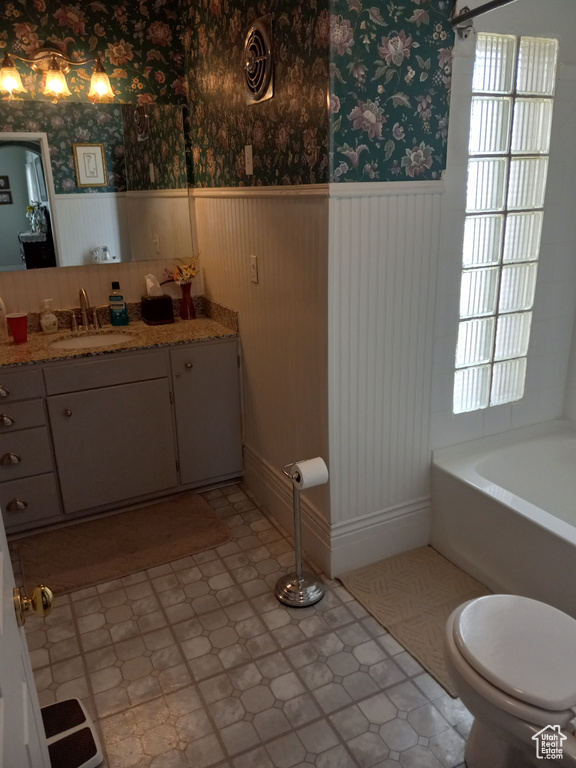 Full bathroom featuring tile flooring, shower / tub combination, vanity, and toilet