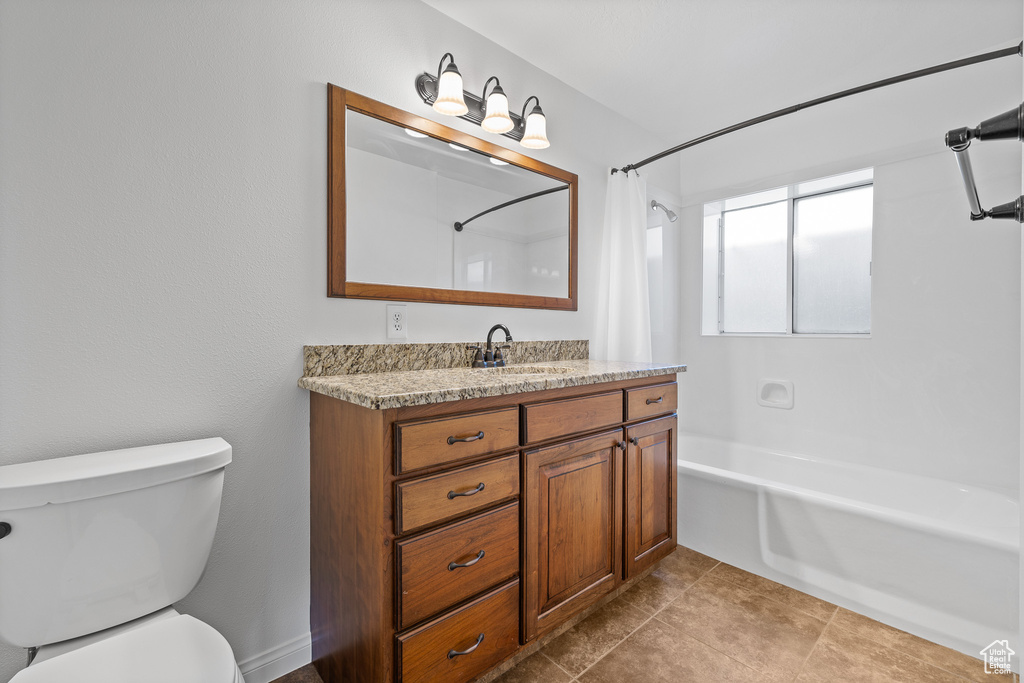 Full bathroom with shower / bath combination with curtain, vanity, toilet, and tile flooring