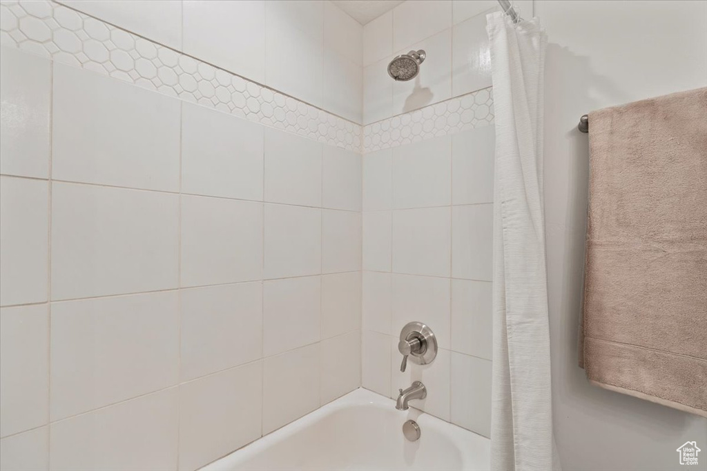 Bathroom with shower / bath combination with curtain