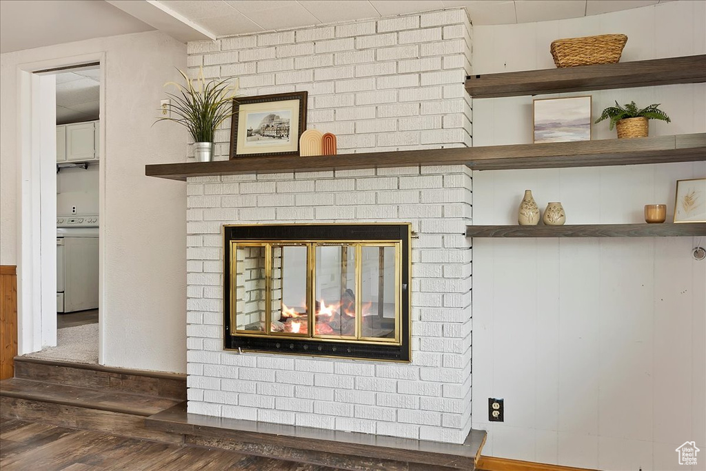 Details with white stove, hardwood / wood-style flooring, and a fireplace