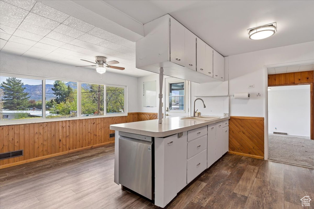 Kitchen featuring white cabinets, wood-type flooring, and dishwasher